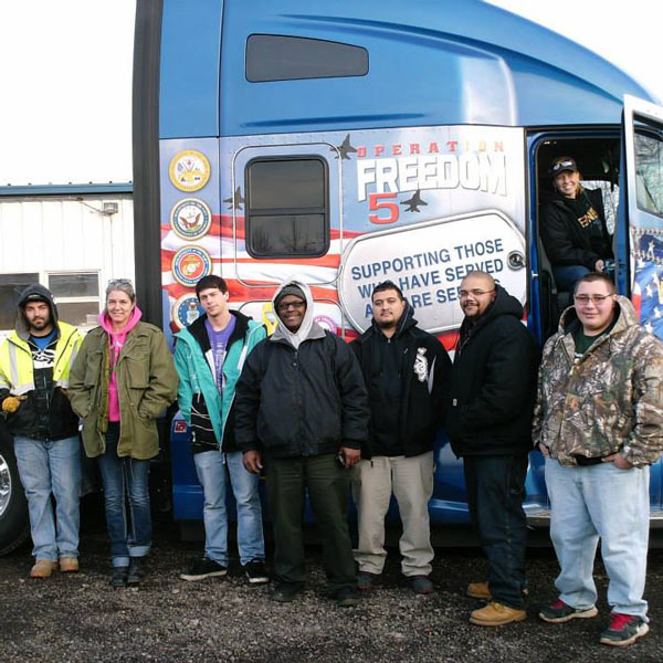 students in front of semi